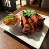Grilled Ribs · Spare pork Ribs marinated with secret house sauce comes with sticky rice and Jaew Mak Lin