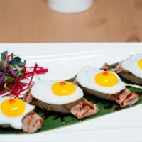 Rib Eye Beef Sushi with Quail Egg · 4 pieces. Lightly seared rib eye beef topped with sunny side up quail egg, sushi style with ...