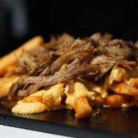 Next Level Cheesy Fries · Topped with juicy, smoky pulled pork.