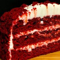 Red Velvet Cake · Layers of red velvet cake engulfed in cream cheese icing and red velvet crumbles 