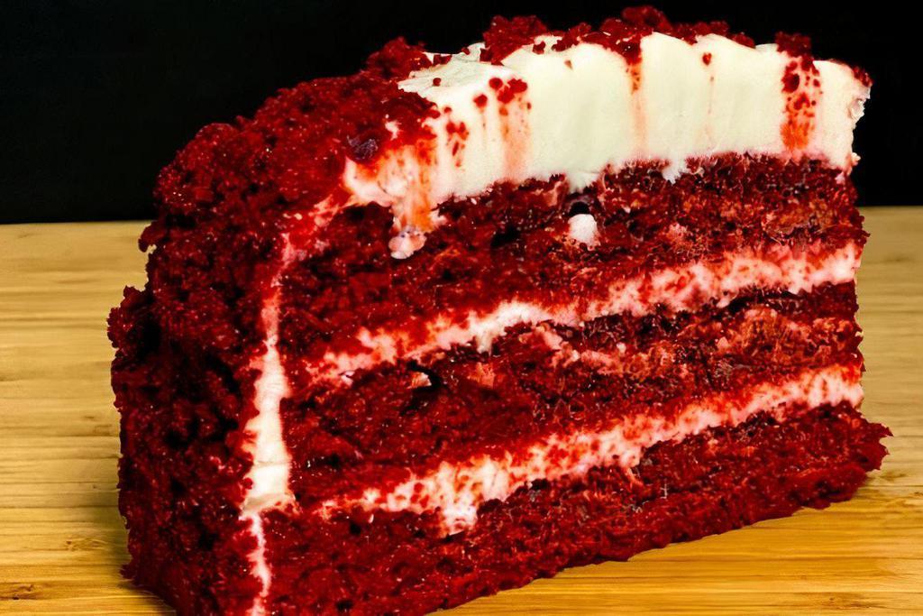 Red Velvet Cake · Layers of red velvet cake engulfed in cream cheese icing and red velvet crumbles 