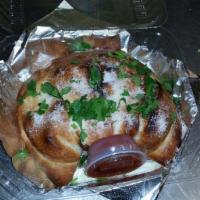 BBQ Chicken Calzone · Chopped BBQ chicken breast, red onions, cilantro, ricotta, and mozzarella cheese. Topped wit...
