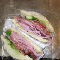 Italian Grinder · Smoked ham, salami, mortadella, melted provolone cheese, lettuce and tomato, topped with Ita...
