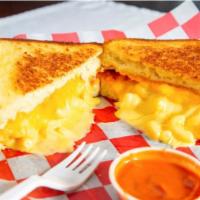 The Mac · American cheese, cheddar cheese spread and housemade macaroni and cheese on Texas toast. Ser...