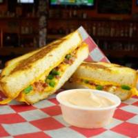 The Popper · Cheddar cheese, cream cheese, cheddar cheese sauce, fresh jalapeño slices and bacon on sourd...