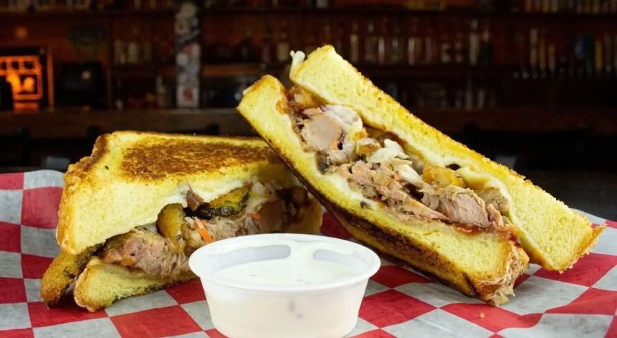 The Edgar · Mozzarella, cheddar cheese, pulled pork, BBQ Sauce, Coleslaw, fried pickles, fried onion strings, on Texas toast. Served w/ ranch.