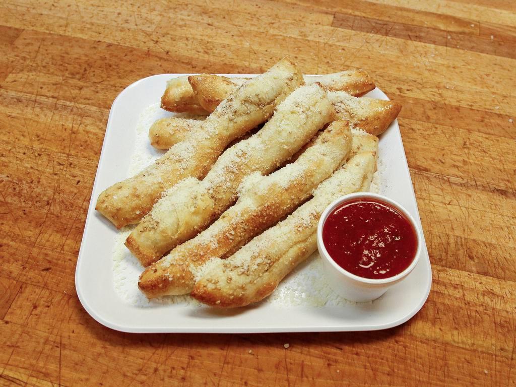 Bread Sticks · Soft sticks with garlic butter, Parmesan and sesame seeds. Served with sauce.