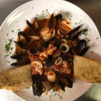 Frutti Di Mare · Shrimp, scallops, mussels, calamari in a fresh tomato and white wine sauce, served over ling...