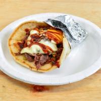 10. Philly Steak Pita · Thinly sliced prime steak, grilled onions, green pepper, Swiss, American cheese, and steak.