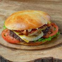 Grilled Onion Burger · 1/3 lb Chuck Patty, American Cheese, Bacon, Mayo, Lettuce, Tomato, Grilled Onions, on a home...