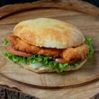 Crispy Chicken Sandwich · 5oz Hand Breaded Crispy Amish Chicken, Chicken Sauce, Lettuce, Tomato, Onions, on a homemade...