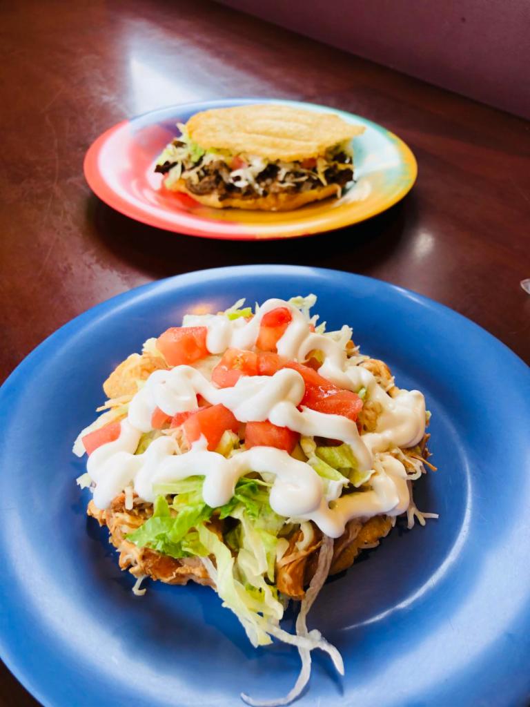 Sopes · Soft corn dough served with choice of meat, beans, lettuce, tomato, onion, cheese, and sour cream.  