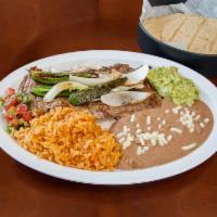 Skirt Steak · Served with rice, beans, grilled onions, grilled jalapeños, pico de Gallo, guacamole and cor...