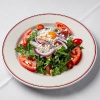 Mixed Heirloom Tomato Salad · Arugula, red onions, feta cheese, and lemon dressing.