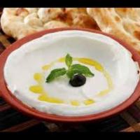 Labneh · Yogurt cream blended with garlic and topped with mint and sprinkled olive oil.