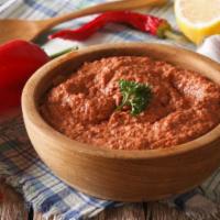 Muhammara · Hot pepper dip. Roasted red peppers and crushed walnuts mixed with crushed wheat and pomegra...