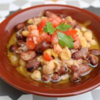 Fool Mudammas · Fava beans stew with garbanzo beans, lemon, spices and drizzled with olive oil.