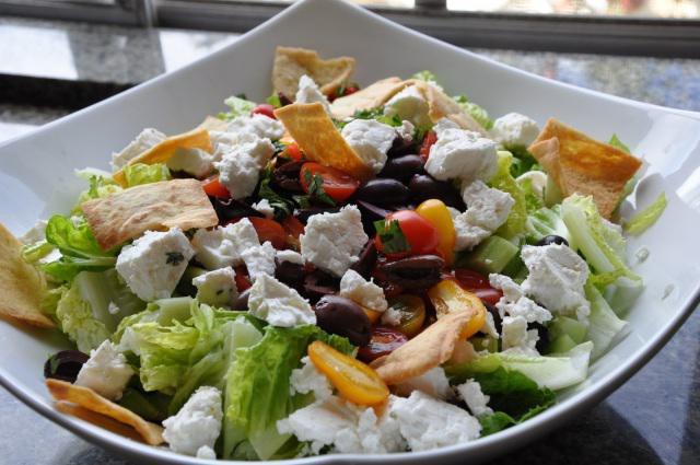 Greek Salad · Feta cheese mixed with romaine lettuce, tomatoes, olives, cucumbers, bell peppers and mixed with lemon juice and olive oil dressing.
