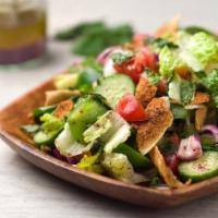 Fattoush Salad · Toasted bread pieces with romaine lettuce, cucumbers, tomatoes, parsley, mint, mixed with le...