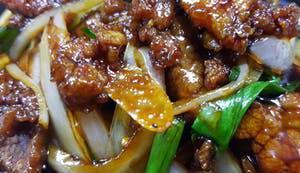 Mongolian Beef · Tender flank steak marinated in 7 Southeast Asian spices, wok tossed, served over green onio...