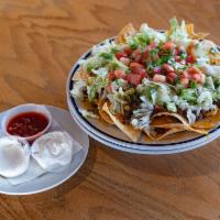 Nachos Supreme · A heaping bed of our house made chips served piled high with seasoned ground beef, tomatoes,...