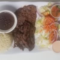 Carne Asada · Grilled steak served with rice, beans and corn tortillas.