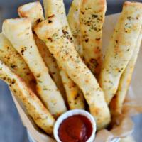 Large Bag of Breadsticks · Includes choice of 2 ranch or 2 marinara sauce or 1 of each.