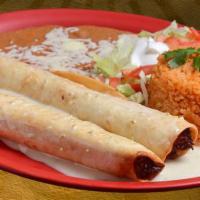 Chicken Flautas Lunch · 2 chicken flautas topped with nacho cheese and served with rice.