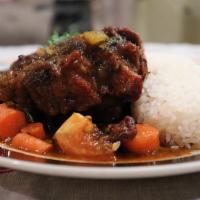 Stewed Oxtails Platter · Oxtails marinated in herbs and spices served with carrots, red beans. Served with your choic...
