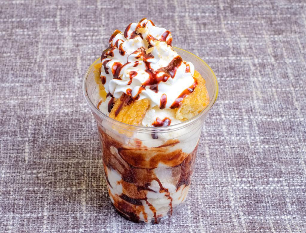 Churro Sundae · Choice of 2 scoops of ice cream, chocolate sauce, and warm churro bites.