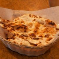 116. Peshwari Naan · Naan bread stuffed with almonds, cashews, peanuts, and raisins and baked in day oven.