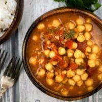 48. Channa Masala · Chickpeas cooked with fresh tomatoes and mild tangy spices.come with rice