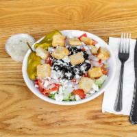 Greek Salad · Iceberg, tomatoes, onions, black olives, feta cheese, peppers and croutons.