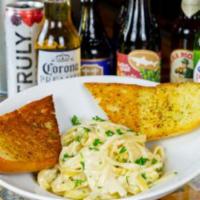 Fettucini Alfredo · Fettuccini, chef's Alfredo sauce. Served with garlic bread. Add chicken for an extra charge.
