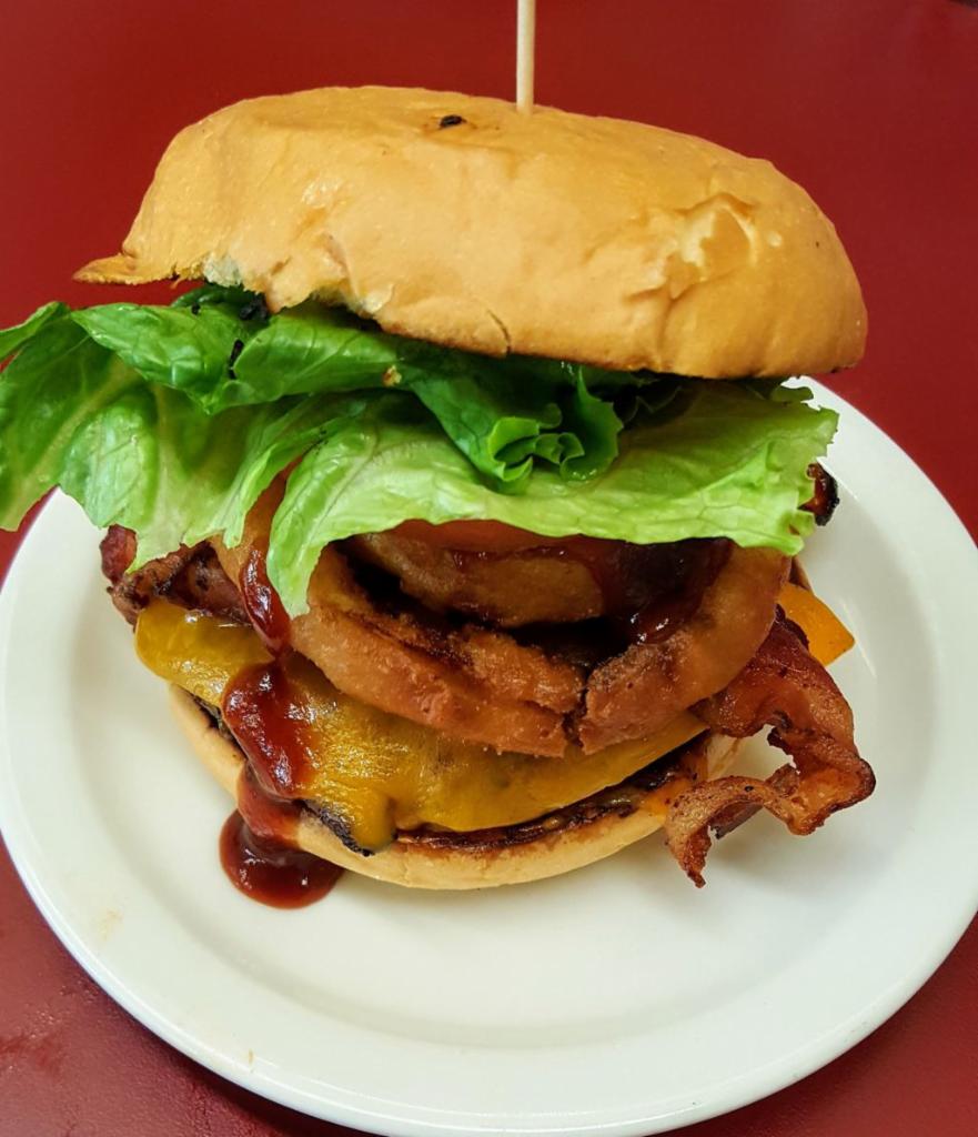 Double Western bacon cheese burger · 2 Angus burgers topped with onion rings crisp bacon on Sweet Baby Ray's BBQ sauce on a toasted Viro's Bun. Served with your choice of side and pickle spear. 