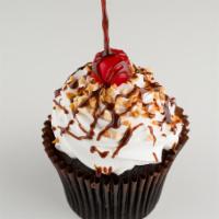 Hot Fudge Sundae Cupcake · 

Fudge filled chocolate cake topped with a buttercream swirl, drizzled with fudge and garni...