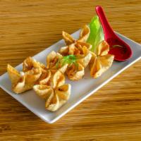 Real Crab Meat Cheese Wonton · Real crabmeat combined with ginger, onion, and cream cheese served with a sweet and sour sau...