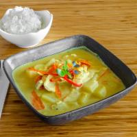Yellow Curry · Thai yellow curry paste with potatoes, onion, and carrot serve with a cucumber salad.