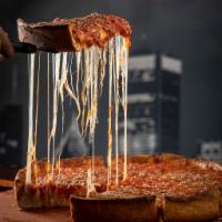 Chicago-Style Deep Dish Pizza · Chicago's famous deep dish is a buttery crust filled with mounds of mozzarella cheese and to...