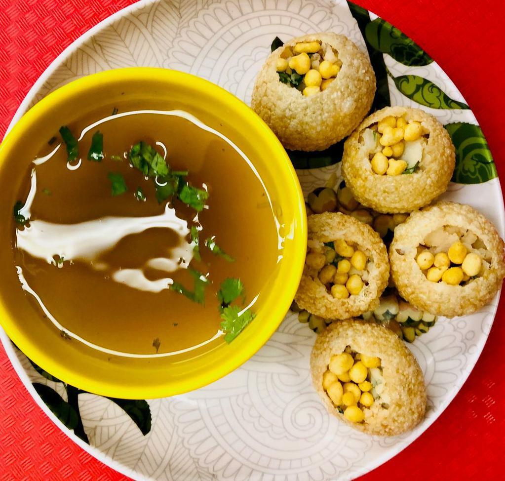 Pani Puri · Round, hollow puri, fried crisp and filled with a mixture of flavored water (pani), tamarind chutney, chili, chaat masala, potato, onion and chickpeas.