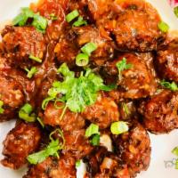 Chicken Manchurian · Flour mixed with tomato, onion and special spices and sauces. Served fried. Served with sauc...