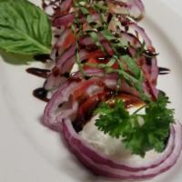Caprese Salad · Tomatoes, fresh mozzarella, red onion, fresh basil and  house dressing.