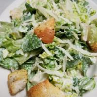 Classic Caesar Salad · Romaine lettuce tossed in Caesar dressing and topped with croutons and Romano cheese.