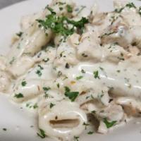 Rigatoni with Grilled Chicken · Homemade pasta in a light cream sauce and fresh basil.