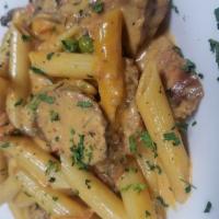 Penne Calabrese · Mushrooms, peas and Italian sausage tossed in a spicy tomato cream sauce.