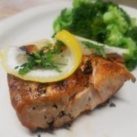 Grilled Salmon · Served with broccoli and roasted potatoes, garnished with lemon.