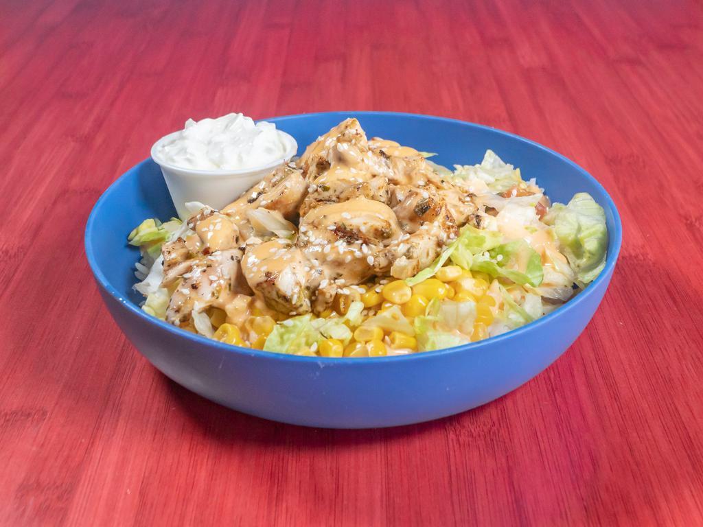 Yum Yum Chicken Bowl · White rice, lettuce, cilantro salsa, corn, yum yum sauce, sour cream, sesame seeds, and black beans.