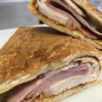 4. Grilled Cubano · Roast pork loin, ham, Swiss, mustard, mayo, relish and hot peppers on pressed French bread 