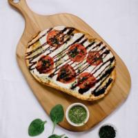 Caprese Flatbread · Pesto, sliced mozzarella, chopped tomato, basil, balsamic.