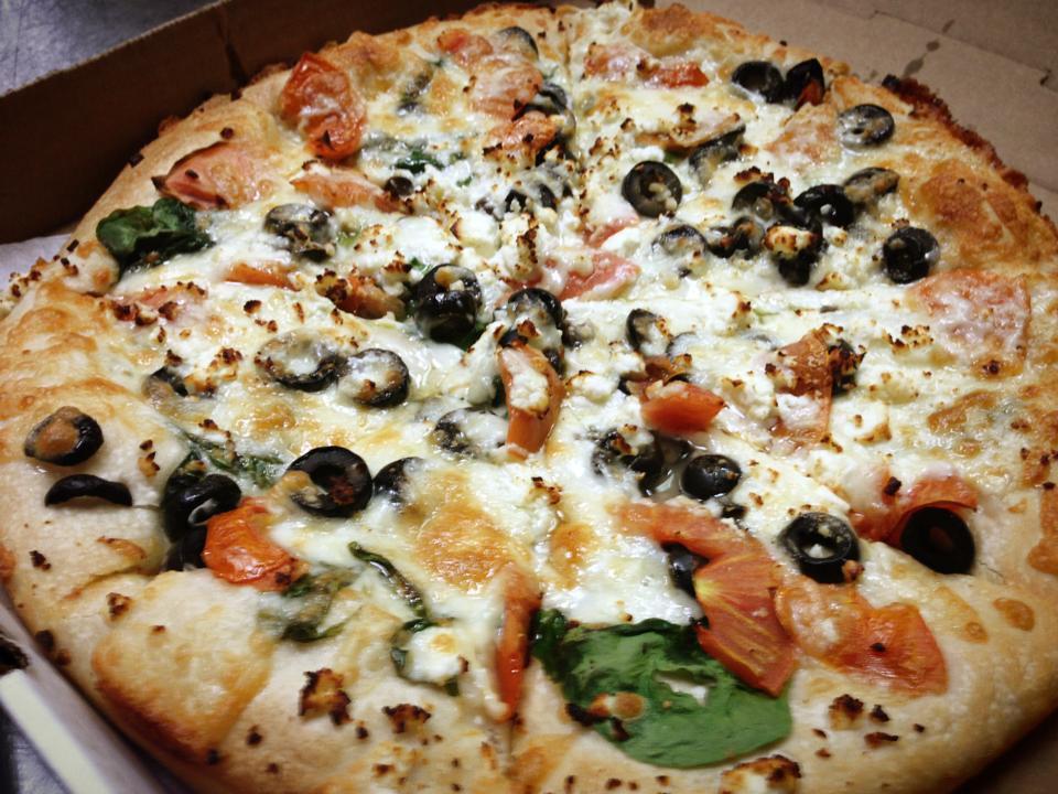 Greek Pizza · Spinach, tomatoes, garlic, olives, and topped with feta cheese.
